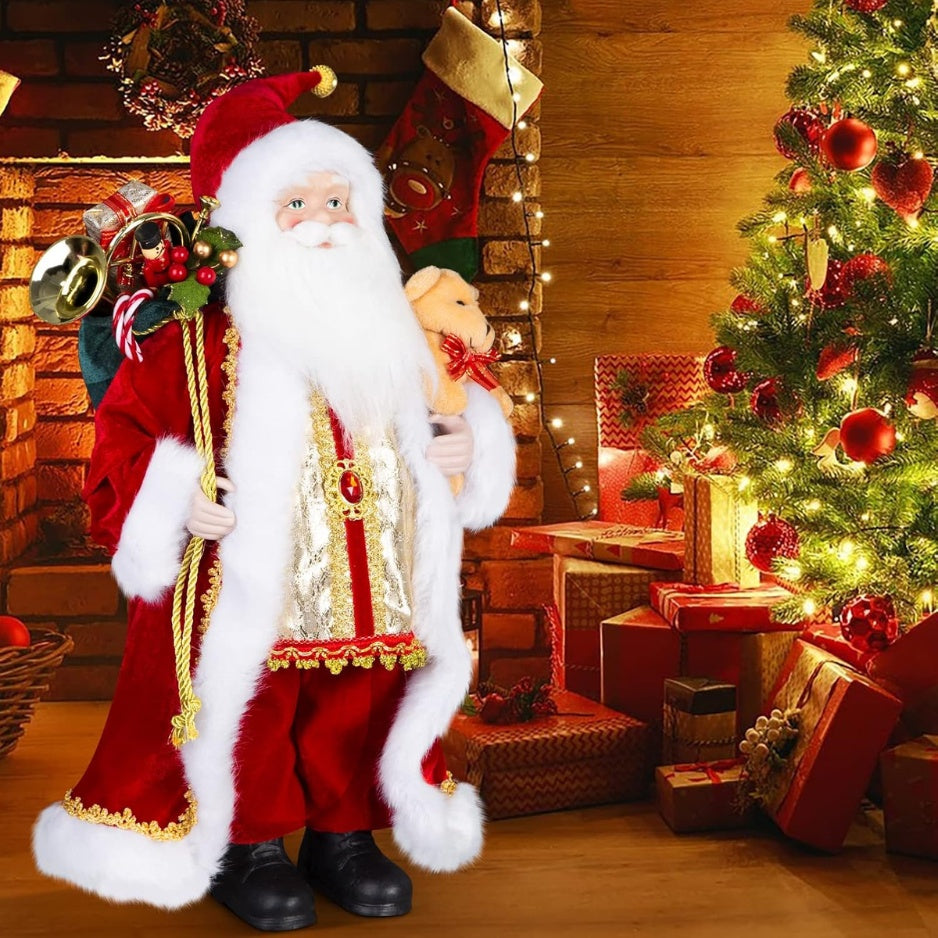 18 inch standing Santa Claus figurine next to a Christmas tree and fireplace